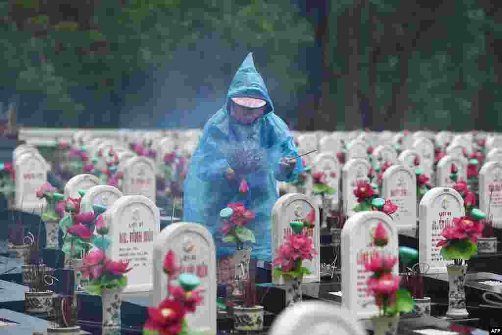 A visitor lights incense sticks at the Truong Son Martyr&#39;s Cemetery, where 10,263 Vietnamese war soldiers are laid to rest, in Quang Tri province, Vietnam.