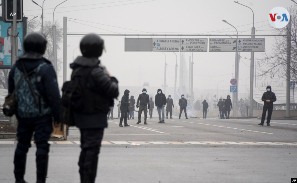 Manifestantes se reúnen frente a las líneas de la policía en la ciudad de Almaty. Protestan por la duplicación de los precios del gas.