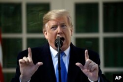 FILE - President Donald Trump speaks during an event in the Rose Garden at the White House to declare a national emergency in order to build a wall along the southern border, Feb. 15, 2019, in Washington.