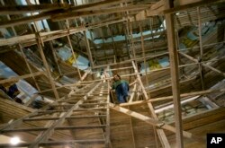 Coptic Christian Ayman William stands on scaffolding inside Mar Girgis Church, in the Zawiya al-Hamra neighborhood of Cairo, Egypt, April 24, 2107. William paints for the glory of God, unfazed by recent attacks against his fellow Coptic Christians in Egypt.