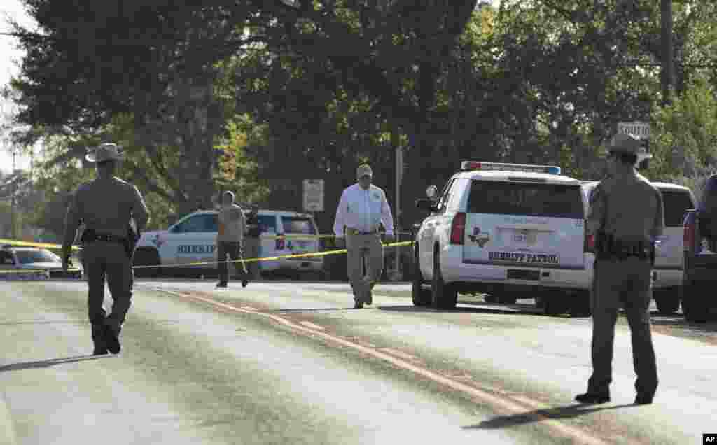 Law enforcement officers work near the First Baptist Church of Sutherland Springs after a fatal shooting, Nov. 5, 2017, in Sutherland Springs, Texas.