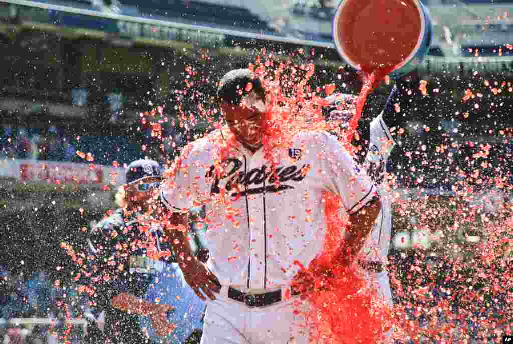 San Diego Padres starting pitcher Tyson Ross is doused by teammates after pitching a complete baseball game 3-0 shutout over the Cincinnati Reds, in San Diego, California, USA, July 2, 2014.