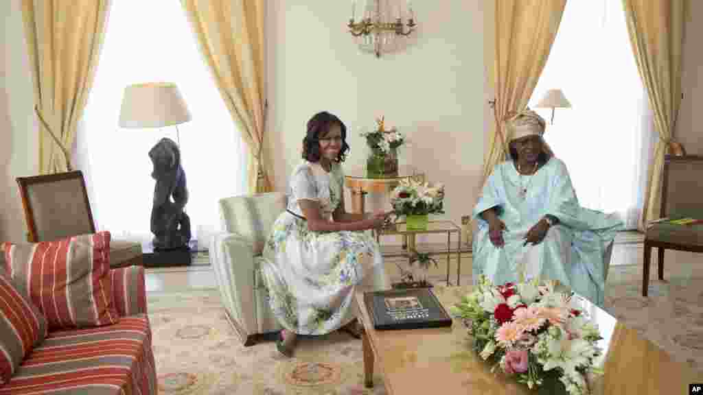 U.S. first lady Michelle Obama and Mariame Faye Sall, first lady of Senegal, talk in the Presidential Palace in Dakar, Senegal, June 27, 2013.