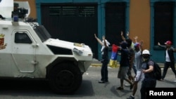 Manifestantes antigubernamentales se plantan frente a un vehículo de la Guardia Nacional durante una protesta en San Cristóbal.