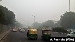 Even during the day visibility was poor on the streets of New Delhi, India, due to high pollution levels, Nov. 6, 2016.
