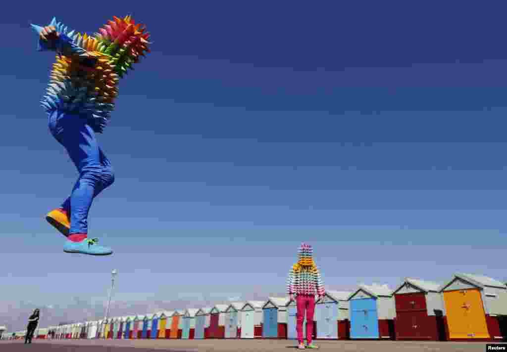 Venezuelan artist Cristobal Ochoa (R) and his performance partner Jean-Paul Fowler promote the Artist Open Houses part of the Brighton Festival on the seafront in Brighton.