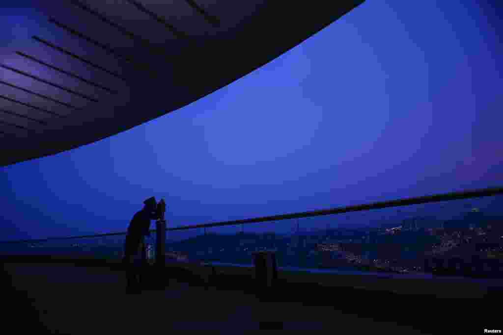 An officer of Malaysia's Islamic authority uses a telescope to perform "rukyah", the sighting of the new moon of Ramadan, in Putrajaya outside Kuala Lumpur. Muslims scan the sky at dusk in the beginning of the lunar calendar's ninth month in search of the new moon to proclaim the start of Ramadan, Islam's holiest month.