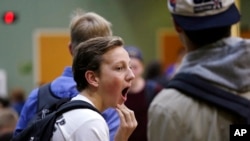 FILE - In this photo taken Nov. 23, 2015, sophomore Ben Early yawns as he stands in his school cafeteria before classes at Roosevelt High School in Seattle. In 2016, the American Medical Association issued a new policy proposal that "encourages middle schools and high schools to start no earlier than 8:30 a.m." (AP Photo/Elaine Thompson)