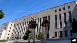 U.S. Marshalls guard the area outside of the federal U.S. District Court in Washington Saturday, June 28, 2014, in anticipation of a court appearance by captured Libyan militant Ahmed Abu Khattala
