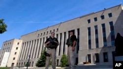 U.S. Marshalls guard the area outside of the federal U.S. District Court in Washington Saturday, June 28, 2014, in anticipation of a court appearance by captured Libyan militant Ahmed Abu Khattala