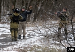 Pro-Russian separatists question a man in the eastern Ukrainian city of Vuhlehirsk, six kilometers southwest of Debaltseve, Feb. 19, 2015.