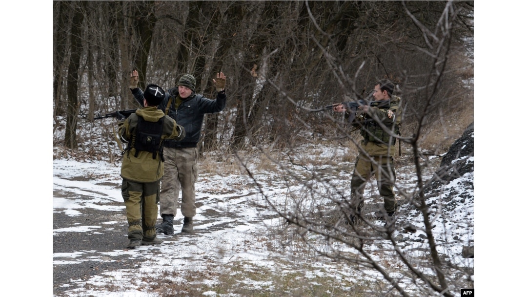 Pro-Russian separatists question a man in the eastern Ukrainian city of Uglegorsk, six kilometers southwest of Debaltseve, Feb. 19, 2015. The leaders of Ukraine, Germany, France and Russia pledged to try to save the tattered cease-fire.