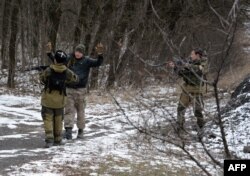 Pro-Russian separatists question a man in the eastern Ukrainian city of Uglegorsk, six kilometers southwest of Debaltseve, Feb. 19, 2015. The leaders of Ukraine, Germany, France and Russia pledged to try to save the tattered cease-fire.
