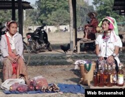 Elderly women from the Padaung tribe sell home-made honey in dis-used whiskey bottles.