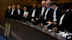 Judges enter the U.N. World Court to deliver their verdict on a request by Bolivia for judges to order Chile to enter talks over granting its landlocked neighbor access to the Pacific Ocean, in The Hague, Netherlands, Oct. 1, 2018. 