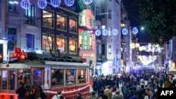 Ljudi šetaju ulicom Istiklal u Istanbulu u novogodišnjhoj noćil, 31. decembra 2024. (Foto: Yasin AKGUL / AFP)