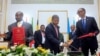 FILE - The Angolan President Joao Lourenço (C) shakes hands with Rwandan president Paul Kagame (R) next to Ugandan President Yoweri Museveni (L) after the signing an agreement to cease hostilities between Uganda and Rwanda, Aug. 21, 2019.