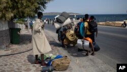 Emigrantët ecin përgjatë qytetit Mitilini, në ishullin Lesbos, (14 shtator 2020) 
