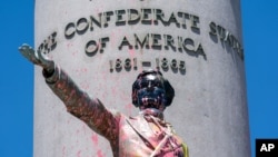 Paint and protest graffiti covers the Jefferson Davis Memorial in Richmond, Va., June 7, 2020, following a week of unrest in the U.S. against police brutality and racism in policing.