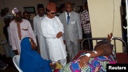FILE - Senator Shehu Sani visit an injured man in a hospital on the outskirts of the city of Zaria, in Kaduna state, Nigeria, July 8, 2015. Sani's revelation that Nigerian senators draw a monthly allowance worth $37,500, in addition to their regular salaries, has drawn widespread anger. 
