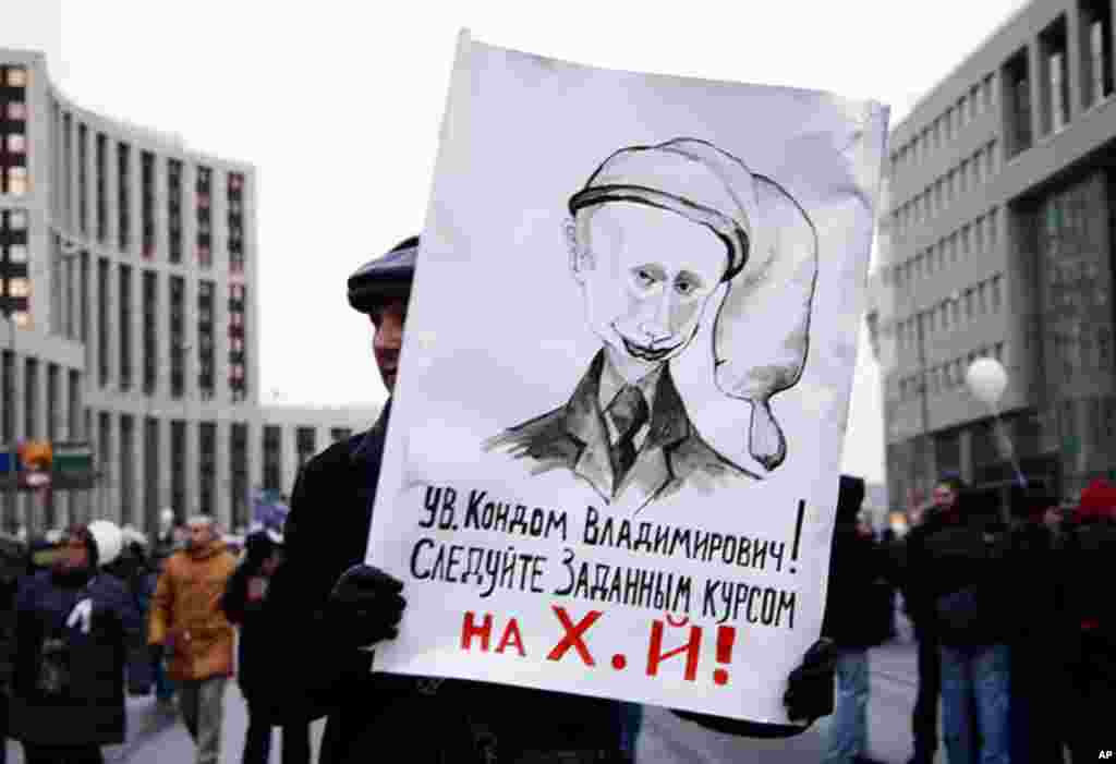 A protester carries a sign depicting Mr. Putin as Condom Vladimirovich, December 24, 2011. (VOA - Y. Weeks)
