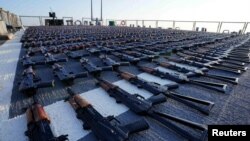 FILE - Thousands of AK-47 assault rifles, seized from a fishing vessel transiting along a maritime route from Iran to Yemen, sit on the flight deck of USS The Sullivans in the Gulf of Oman, in this photo taken Jan. 7, 2023 and released by U.S. Naval Forces on Jan. 10, 2023. 