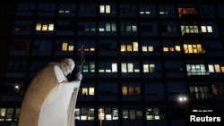 Pope Francis is being treated at Gemelli Hospital in Rome. A statue of the late John Paul II stands outside the medical facility.