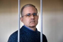 FILE - Paul Whelan, a former U.S. marine, who was arrested for alleged spying in Moscow at the end of 2018, stands in a cage while waiting for a hearing in a court room in Moscow, Russia, Aug. 23, 2019.