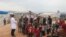 A doctor talks with refugees at a camp for displaced people in Atme, in Syria's northwestern Idlib province, near the border with Turkey, March 14, 2020. 