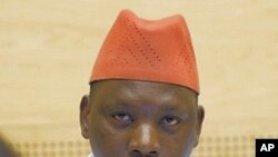 Thomas Lubanga, an alleged Congolese warlord, looks up from behind a computer screen as he waits for the International Criminal Court to announce whether it will halt the court's first trial and release the defendant, in The Hague, Netherlands, 8 Oct. 201