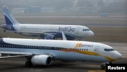 FILE - An IndiGo Airlines Airbust A320 aircraft and JetKonnect Boeing 737 aircraft taxi at Mumbai's Chhatrapathi Shivaji International Airport, Feb. 3, 2013. 