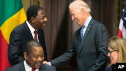 Vice President Joe Biden, right, shakes hands with Benin's president Thomas Boni Yayi, during a Compact Signing Ceremony on Sept. 9, 2015, in Washington. The compact is for a $375 million Millennium Challenge Corporation grant.