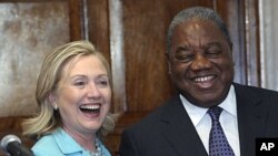 Secretary of State Hillary Rodham Clinton and Zambia's President Rupiah Banda share a laugh following their press availability at the State House in Lusaka, Zambia, Friday, June 10, 2011