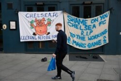 A Chelsea fan walks past banners outside the stadium after reports suggest they are set to pull out of the European Super League, London, Britain, April 20, 2021.