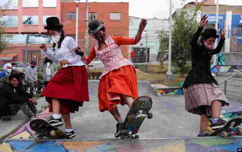 Milenda Limachi, left, Yanira Villarreal, center, and Ayde Choque, dressed as a &quot;Cholitas&quot; ride their skateboards during a youth talent show in La Paz, Bolivia, Sept. 30, 2020