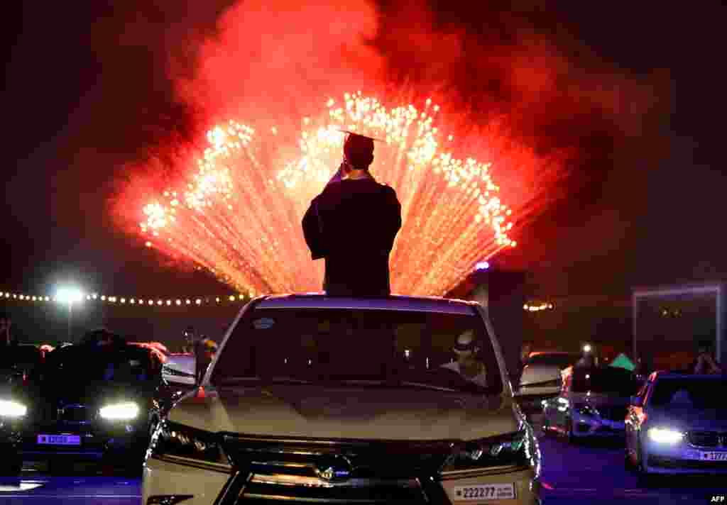 High school seniors of Bahrain Bayan School and their families watch fireworks at Bahrain International Circuit (BIC) in Sakhir race track, June 10, 2020, south of Manama following a graduation ceremony.