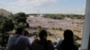 People watch as Belarusian opposition supporters rally in the center of Minsk, Belarus, Aug. 16, 2020. 