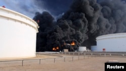 Smoke rises from an oil tank fire in Es Sider port, Libya, Dec. 26, 2014.