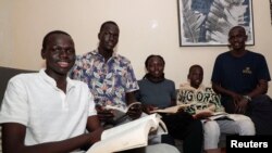 South Sudanese refugees Thon Makech Mach, Magot Makech Mach, Ajoh Makech Mach and Makuei Makech Mach sit with their American uncle Mangok Bol, who resettled in the U.S. decades ago, in Zimmerman, Kasarani district of Nairobi, Kenya, December 15, 2023.