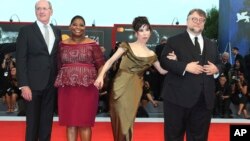 Director Guillermo Del Toro, from right, actors Sally Hawkins, Octavia Spencer and Richard Jenkins pose for photographers upon arrival at the premiere of the film 'The Shape of Water' Aug. 31, 2017. 