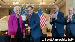 House Speaker Mike Johnson, R-La., center, presents a Congressional Gold Medal to Ann Hammond, daughter of NASA's Dorothy Vaughan, in Washington, Wednesday, Sept. 18, 2024.