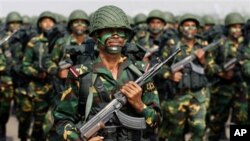 Tibetan Buddhists and tourists view a giant thangka, a religious silk embroidery or painting displaying the Buddha portrait, during the Shoton Festival at Drepung Monastery in Lhasa, Tibet Autonomous Region.