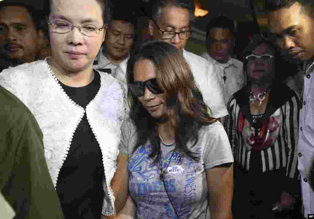 Maria Kristina Sergio (center) is escorted after a press conference by Philippine officials at Camp Crame police headquarters in suburban Quezon city, north of Manila, April 29, 2015.