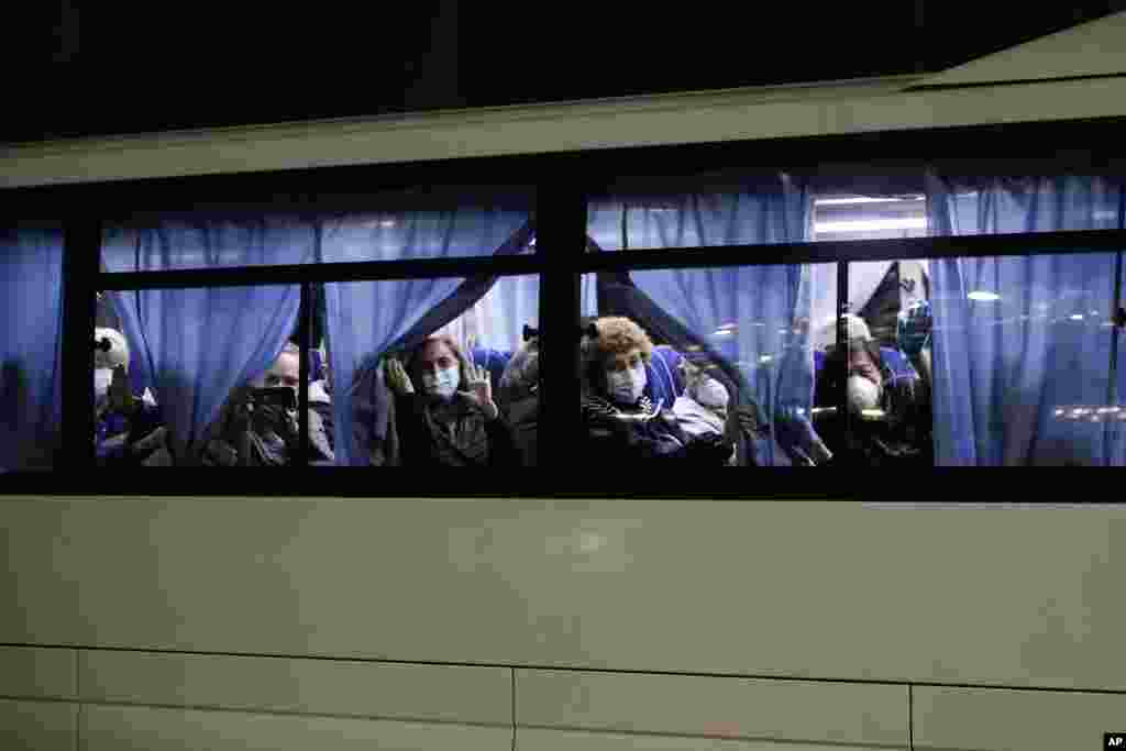 Buses carrying passengers from the quarantined Diamond Princess cruise ship leave a port in Yokohama, near Tokyo, Japan.