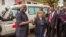 Sierra Leone's president Ernest Bai Koroma, left, is handed the keys to an ambulance by U.S. Embassy representative Kathleen FitzGibbon, center, one of five ambulances donated by the U.S. to help combat the Ebola virus in the city of Freetown, Sierra Leon