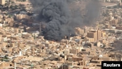 FILE - An aerial view of black smoke and fire at Omdurman market, in Omdurman, Sudan, May 15, 2023.