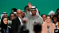 FILE - United Nations Climate Chief Simon Stiell, from left, COP28 President Sultan al-Jaber and Hana Al-Hashimi, chief COP28 negotiator for the United Arab Emirates, pose at the end of the COP28 U.N. Climate Summit, December 13, 2023, in Dubai, United Arab Emirates