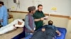 Injured men receive treatment at a hospital in Quetta, Pakistan, Oct. 11, 2024, following Thursday attack by gunmen in Balochistan province.