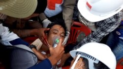 Medics attempt to treat an injured man with gunshot wounds in Dawei, Myanmar, Feb. 28, 2021, in this still image from video obtained via social media. (DAKKHINA INSIGHT)