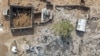 This picture shows an aerial view of people inspecting the damage at a site targeted by airstrikes, carried out the night before by Jordan on the village of Al-Taf in the Al-Lajat region, located in the northeastern countryside of Daraa, on October 27, 2026.